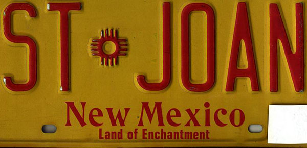 photograph of a New Mexico license plate with St Joan stamped on it.